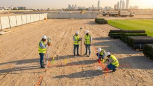 Professional engineers performing a site inspection for a sports field project in Abu Dhabi شركات إنشاء ملاعب رياضية في الإمارات
